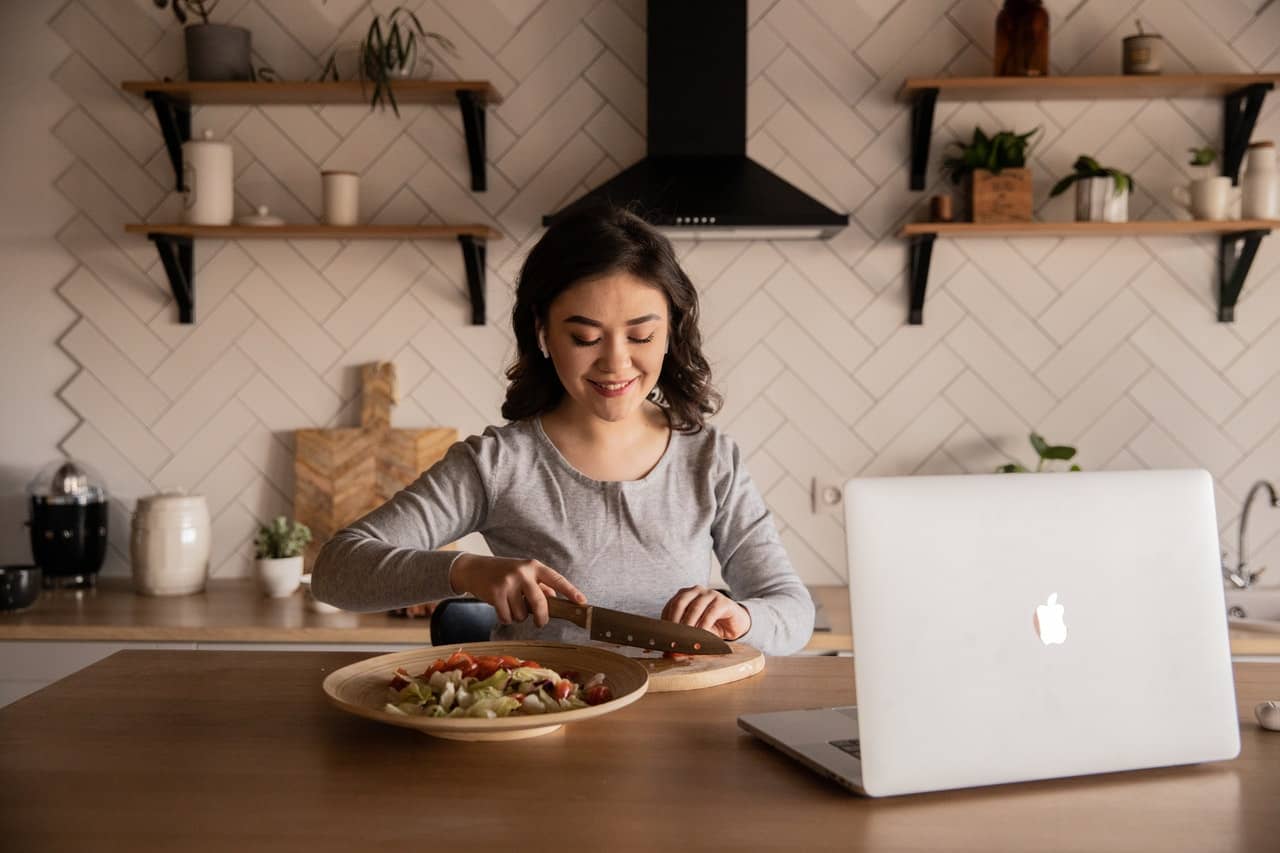 Person Cooking in Front of Computer